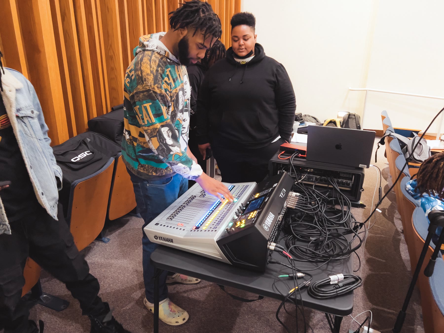 MPT students participating in a live sound session simulation with a digital console